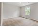 Spacious bedroom with carpeted floors and a large window at 900 Rhino Bnd, Oxford, NC 27565
