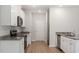 White kitchen cabinets, granite countertops, and stainless steel appliances at 900 Rhino Bnd, Oxford, NC 27565