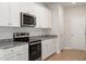 Black stove, stainless steel microwave, and granite countertops at 900 Rhino Bnd, Oxford, NC 27565