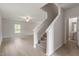 Open staircase with carpet runner and light-colored hardwood floors at 900 Rhino Bnd, Oxford, NC 27565