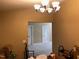 Dining area with chandelier and view into adjacent room at 929 Morreene Rd # B-34, Durham, NC 27705