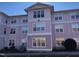 Three-story building with light pink exterior and ample windows at 929 Morreene Rd # B-34, Durham, NC 27705