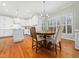 Kitchen with white cabinets, island and breakfast nook at 101 Promontory Point Dr, Cary, NC 27513