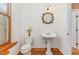 Small bathroom with pedestal sink and tile floor at 105 Kingfisher Way, Louisburg, NC 27549