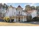 Elegant two-story home with stone accents and a charming front porch at 105 Kingfisher Way, Louisburg, NC 27549