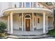 Grand entrance with stone detailing and a covered porch at 105 Kingfisher Way, Louisburg, NC 27549