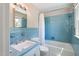 Bathroom with blue tile, bathtub shower combo, and vanity at 127 Fairfield Cir, Dunn, NC 28334