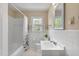 Clean bathroom with white tile, bathtub shower combo, and updated vanity at 127 Fairfield Cir, Dunn, NC 28334