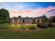 Brick ranch house with landscaped yard, showcasing a welcoming front porch at 127 Fairfield Cir, Dunn, NC 28334