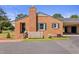 Brick house exterior with green shutters, a spacious yard, and a detached garage at 127 Fairfield Cir, Dunn, NC 28334