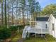 Landscaped backyard with deck, pergola, and water view at 1408 Ferrell Ct, Creedmoor, NC 27522