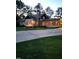 House exterior view at dusk, showcasing a large porch and driveway at 1521 Cross Link Rd, Raleigh, NC 27610
