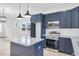 Modern kitchen with dark blue cabinets, granite countertops, and stainless steel appliances at 206 3Rd St, Erwin, NC 28339