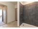 Bathroom with grey tile shower and view of hallway at 2204 Gathering Square Ct, Fuquay Varina, NC 27526
