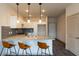 Modern kitchen with granite countertops and island seating at 2204 Gathering Square Ct, Fuquay Varina, NC 27526