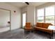 Open living room with a view of the kitchen, featuring leather seating and wood-look floors at 2204 Gathering Square Ct, Fuquay Varina, NC 27526