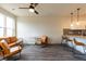 Open living area showcasing a kitchen, leather seating, and wood-look floors at 2204 Gathering Square Ct, Fuquay Varina, NC 27526