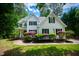 White two-story house with black shutters, landscaping, and a brick walkway at 3200 Keighley Forest Dr, Wake Forest, NC 27587