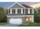 Two-story house with brick and siding exterior, two-car garage, and landscaping at 518 Donnegal Farm Dr, Fuquay Varina, NC 27526