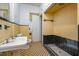 Bathroom with yellow and black tile, sink and shower at 603 W Davis St, Burlington, NC 27215