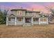 Two-story house with wrap-around porch and mature trees at 603 W Davis St, Burlington, NC 27215