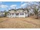 Two-story home with wrap-around porch and mature trees at 603 W Davis St, Burlington, NC 27215