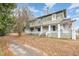 Two-story home with wrap-around porch and mature trees at 603 W Davis St, Burlington, NC 27215