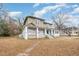 Two-story home with wrap-around porch and mature trees at 603 W Davis St, Burlington, NC 27215