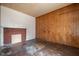Living room with brick fireplace and wood paneling at 603 W Davis St, Burlington, NC 27215