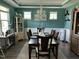 Bright dining room with a large table, chandelier, and teal walls at 70 Maxwell Pl, Lillington, NC 27546