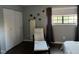 Bedroom with hardwood floors, a comfortable chair, and spacious closet at 807 W Trinity Ave # 241, Durham, NC 27701