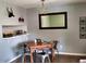 Bright dining area with a table and chairs, hardwood floors, and a built-in shelf at 807 W Trinity Ave # 241, Durham, NC 27701