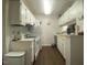 Clean kitchen with white cabinets, appliances, and dark hardwood floors at 807 W Trinity Ave # 241, Durham, NC 27701