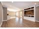 Spacious living room featuring hardwood floors and a rustic wood accent wall at 119 Elmsford St, Durham, NC 27703