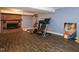 Basement with fireplace and exercise equipment at 1354 Mudham Rd, Wendell, NC 27591