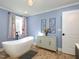 Spa-like bathroom featuring a soaking tub and stylish decor at 1354 Mudham Rd, Wendell, NC 27591