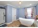 Elegant bathroom with freestanding tub, shower, and tile flooring at 1354 Mudham Rd, Wendell, NC 27591