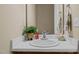 Clean bathroom with a single sink vanity, mirror, and towel rack at 1674 Snowmass Way, Durham, NC 27713