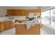 Kitchen with island, wood cabinets, and stainless steel appliances at 1674 Snowmass Way, Durham, NC 27713