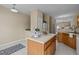 Kitchen with island, wood cabinets, and view to living room at 1674 Snowmass Way, Durham, NC 27713