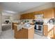 Kitchen features an island, wood cabinets, and stainless steel appliances at 1674 Snowmass Way, Durham, NC 27713