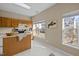 Kitchen boasts an island, wood cabinets, and sunny window at 1674 Snowmass Way, Durham, NC 27713