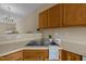 Kitchen features a double sink, wood cabinets, and modern faucet at 1674 Snowmass Way, Durham, NC 27713