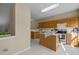 Kitchen with island, wood cabinets, and stainless steel appliances at 1674 Snowmass Way, Durham, NC 27713