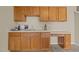 Basement wet bar with wood cabinetry, countertop, and sink at 1674 Snowmass Way, Durham, NC 27713