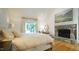 Spacious main bedroom with king-size bed and stone fireplace at 2213 Weybridge Dr, Raleigh, NC 27615