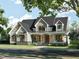 Two-story craftsman style home with gray siding, shutters, and a covered porch at 30 Hidden Lake Dr, Franklinton, NC 27525