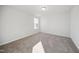 Simple bedroom with gray carpeting and a window at 3712 Massey Pond Trl, Raleigh, NC 27616