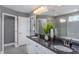 Bathroom features double vanity with dark countertop and large mirror at 47 Rosedale Way, Pittsboro, NC 27312