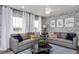 Spacious bonus room with two sofas and a brick accent wall at 47 Rosedale Way, Pittsboro, NC 27312